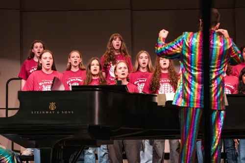 Choir singing behind the grand piano
